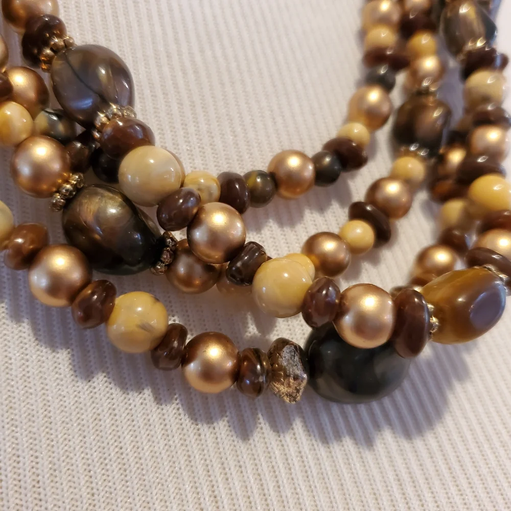 Multi-strand necklace in gold, brown, cream and faux tiger eye beads